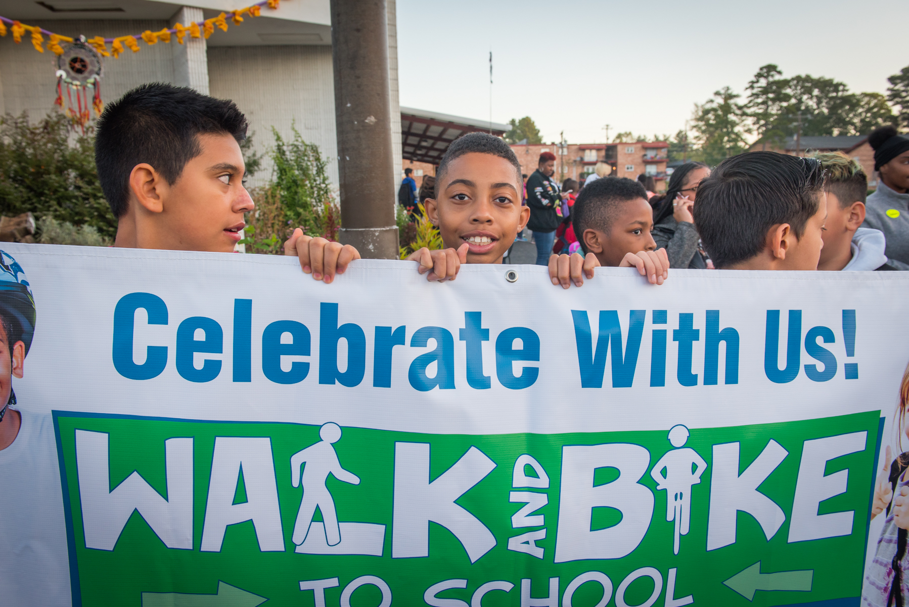 kids holding a banner for walk and bike to school day.