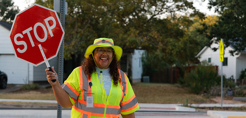 crossing guard holding stop sign