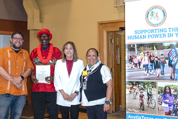 four crossing guards next to a banner